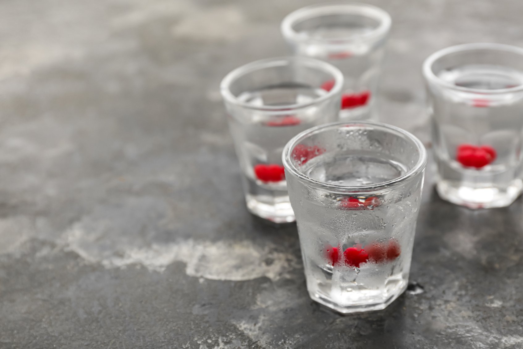 Shots with Cold Vodka on Grunge Background